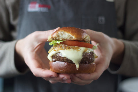 A sous vide burger with cheese, tomato and lettuce