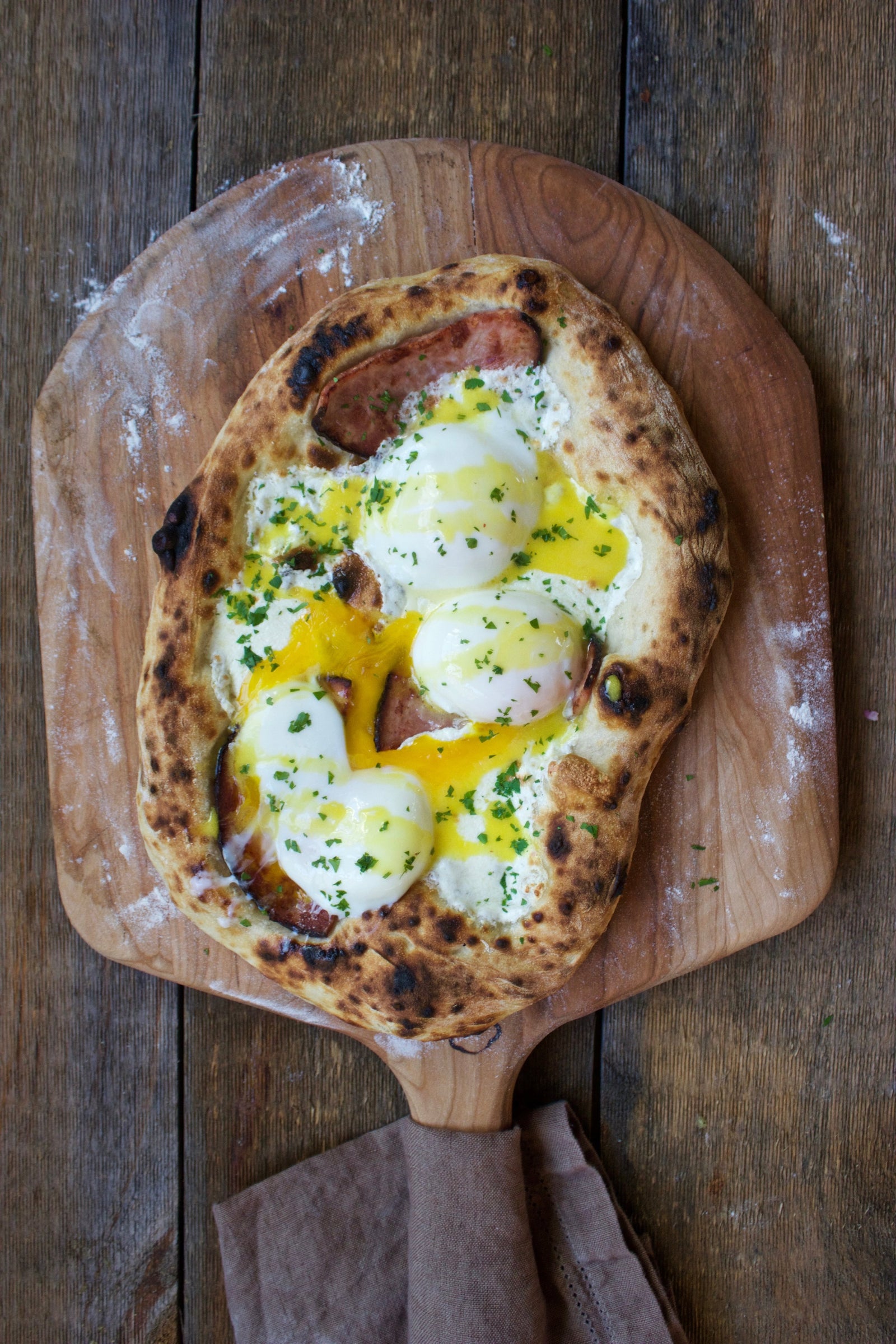 eggs on a cooked pizza dough