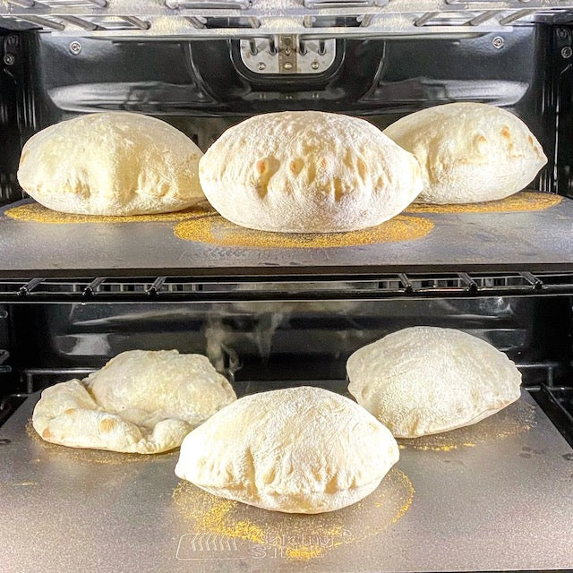 Pita breads cooking in oven