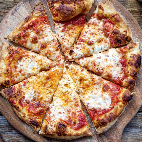 72-hour cold fermented pizza sliced on a wooden peel — baked on a Baking Steel using organic bread flour