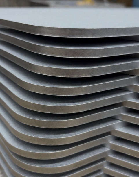 Stack of raw Baking Steel® originals at the Stoughton Steel factory in Hanover, Massachusetts — where every Baking Steel is made in the USA.