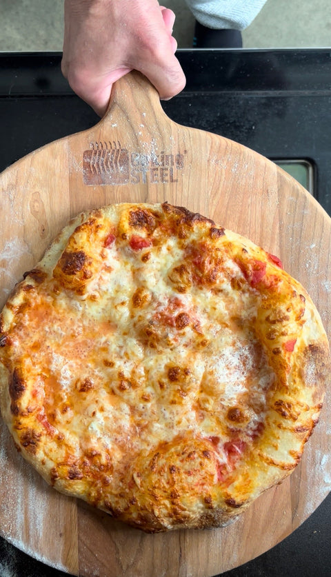 whole foods pizza dough baked on a Baking Steel, with sauce and cheese.