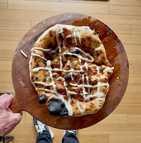 cinnamon bun pizza on a pizza peel