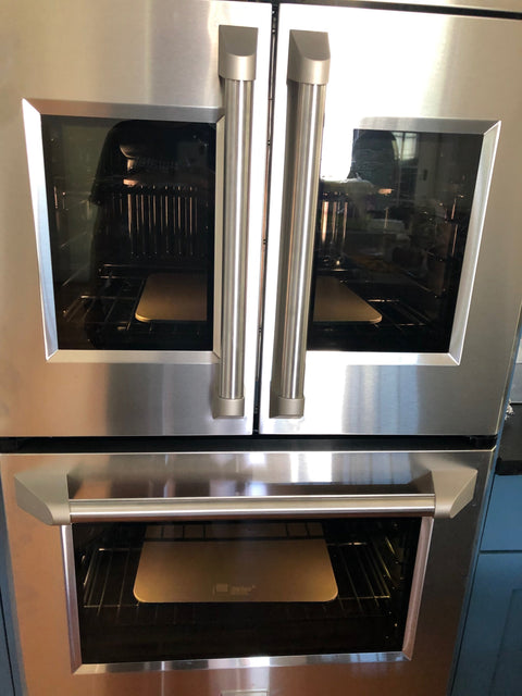 Baking Steels preheating inside a home oven on oven racks ready for pizza night