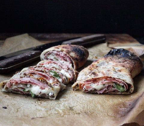 stromboli sliced with the cheese oozing out.