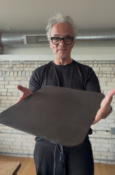 Andris Lagsdin, inventor of the Baking Steel, holding an Original pizza steel