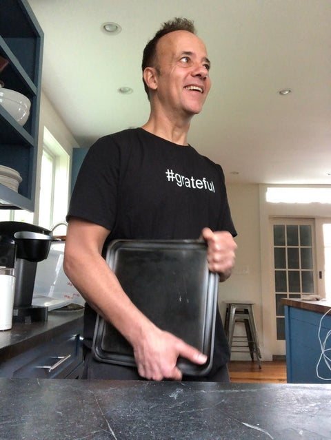 Founder of Baking Steel Company, Andris Lagsdin seen in his kitchen holding a Baking Steel Mini