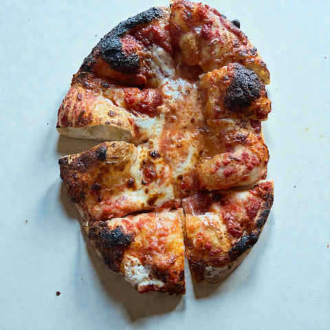 puffy pizza baked on a Baking Steel...sliced 