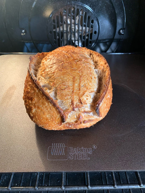 Sourdough loaf baking on a Baking Steel Original inside an oven