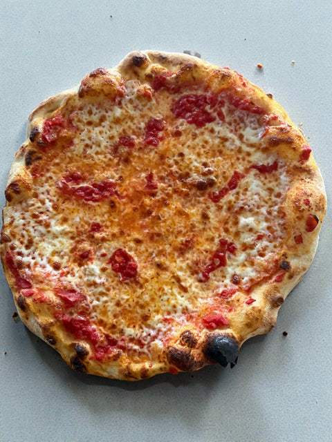 Two cheese pizza with provolone and mozzarella made on a Baking Steel